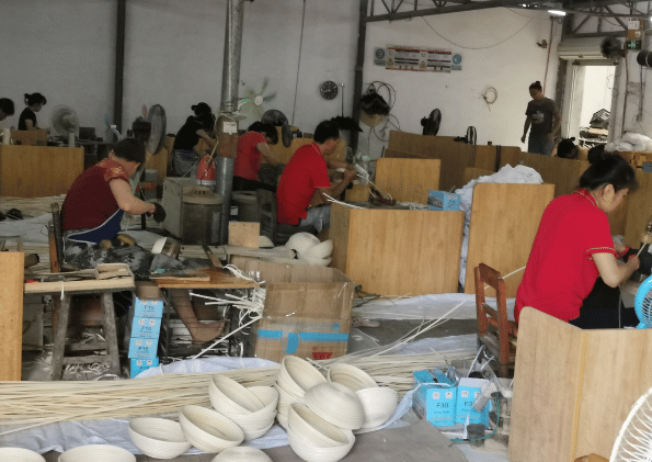 Labour intensive industry: Workers weave rattan baskets